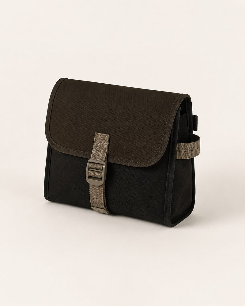 Beta Clutch, near-black canvas with dark-brown flap and taupe buckle